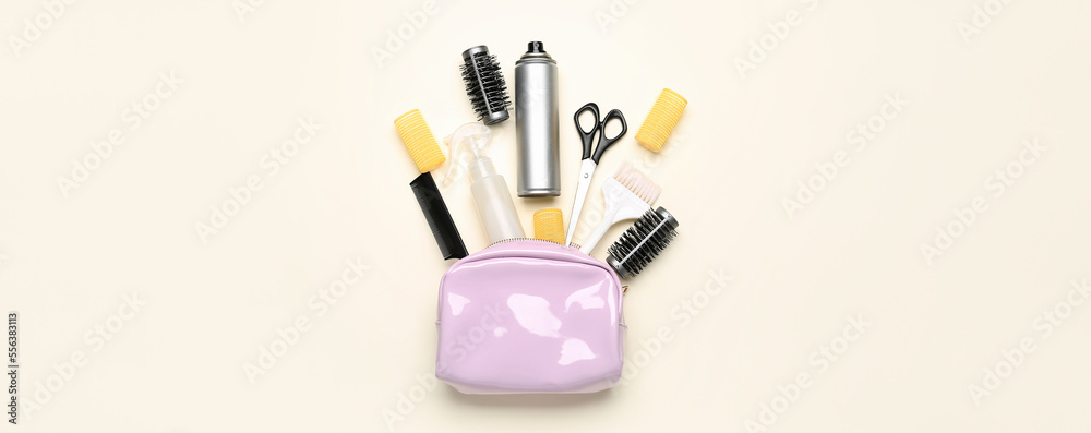 Bag with hair spray and hairdressing accessories on light background