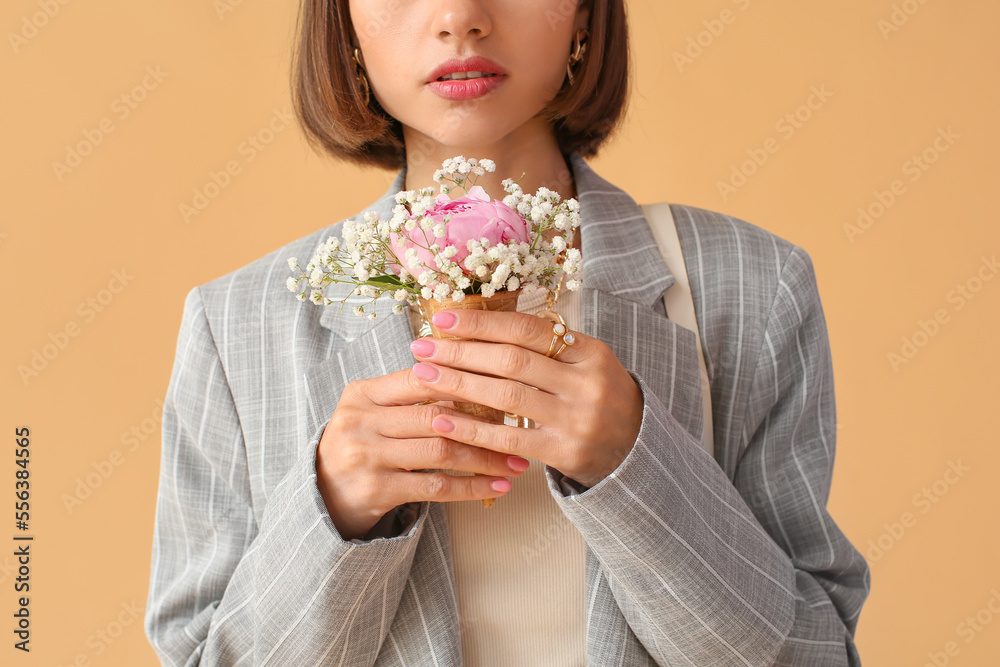 Young woman with beautiful manicure and stylish jewelry holding bouquet of flowers on color background, closeup Young woman with beautiful manicure and stylish jewelry holding bouquet of flowers on color background, closeup