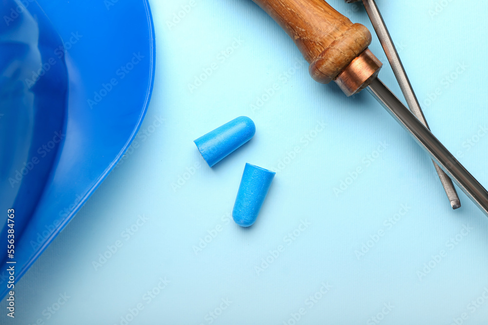 Earplugs and screwdrivers on color background Earplugs and screwdrivers on color background