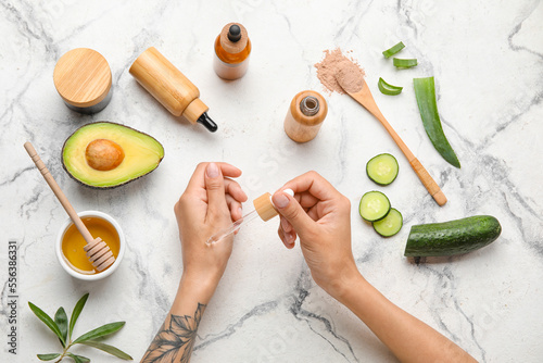 Woman applying essential oi...