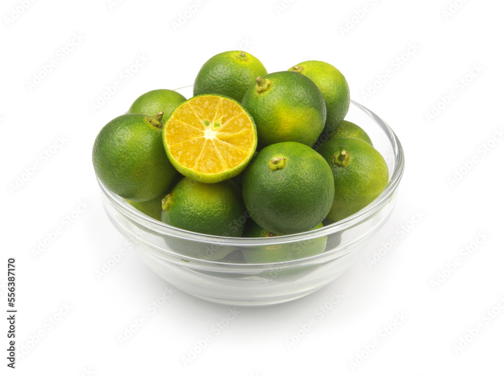 Fresh lime fruits in glass bowl isolated on white background. Fresh lime fruits in glass bowl isolated on white background.