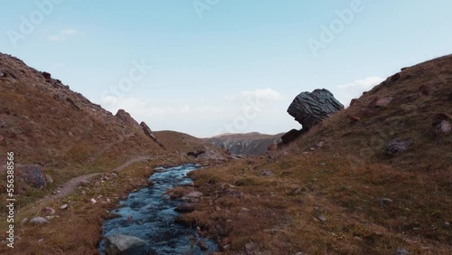 Low flying drone following a mountain stream in Kyrgyzstan photo