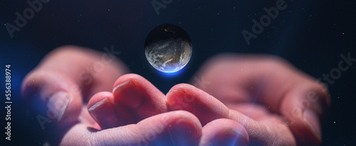Close up of senior hands giving small planet earth to a child isolated on white background