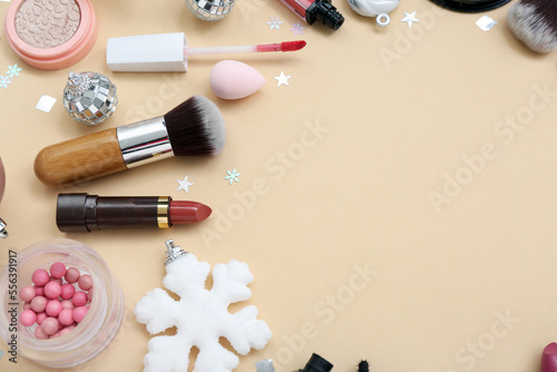 Composition with cosmetics, makeup accessories and Christmas decorations on color background