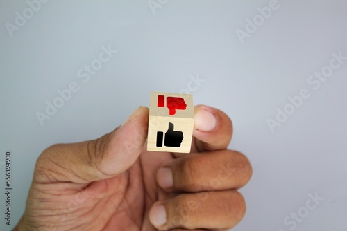 good and bad wooden cubes. curse thumbs up or down on the wooden cube. Concepts are accepted and rejected. Like and dislike icons