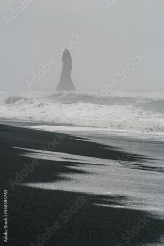 Beach with cliff at storm monochrome landscape photo. Beautiful nature scenery photography with fog on background. Idyllic scene. High quality picture for wallpaper, travel blog, magazine, article © Gypsy On The Road