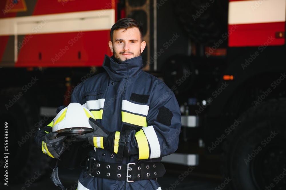 Firefighter portrait on duty. Photo fireman with gas mask and helmet near fire engine. Firefighter portrait on duty. Photo fireman with gas mask and helmet near fire engine.