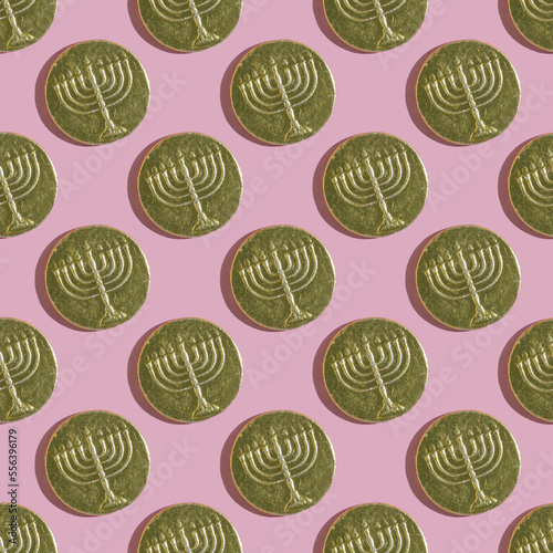 Seamless pattern with Hanukkah gelt on pink background. Chocolate money for Jewish holiday Hanukkah.