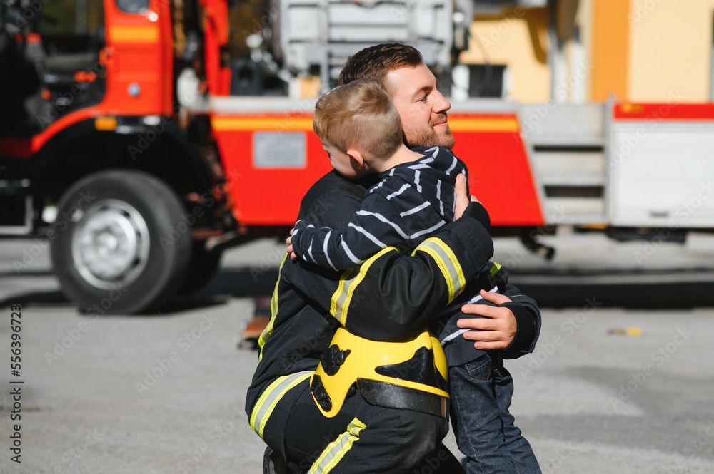 Firefighter holding child boy to save him in fire and smoke,Firemen rescue the boys from fire