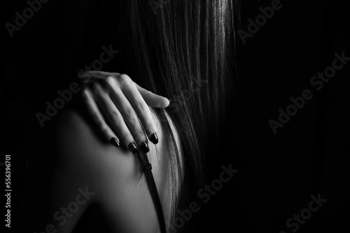 Female beautiful hand black and white photo on a black background, conceptual creative