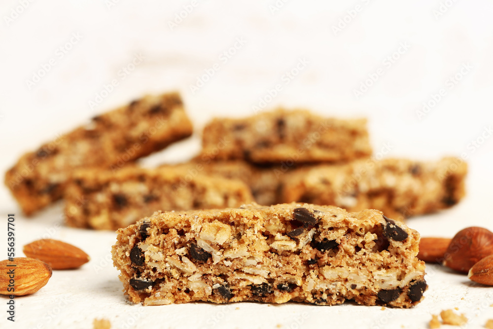 Tasty biscotti cookies and almond nuts on light background Tasty biscotti cookies and almond nuts on light background