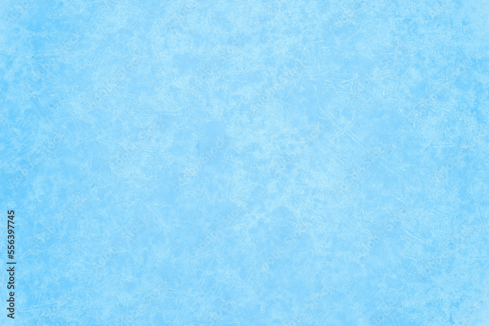 Pure blue ice with the texture of a pattern of beautiful frost veins in a light haze of light. Background concept