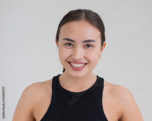 Portrait of a smiling Asian woman on a white background.