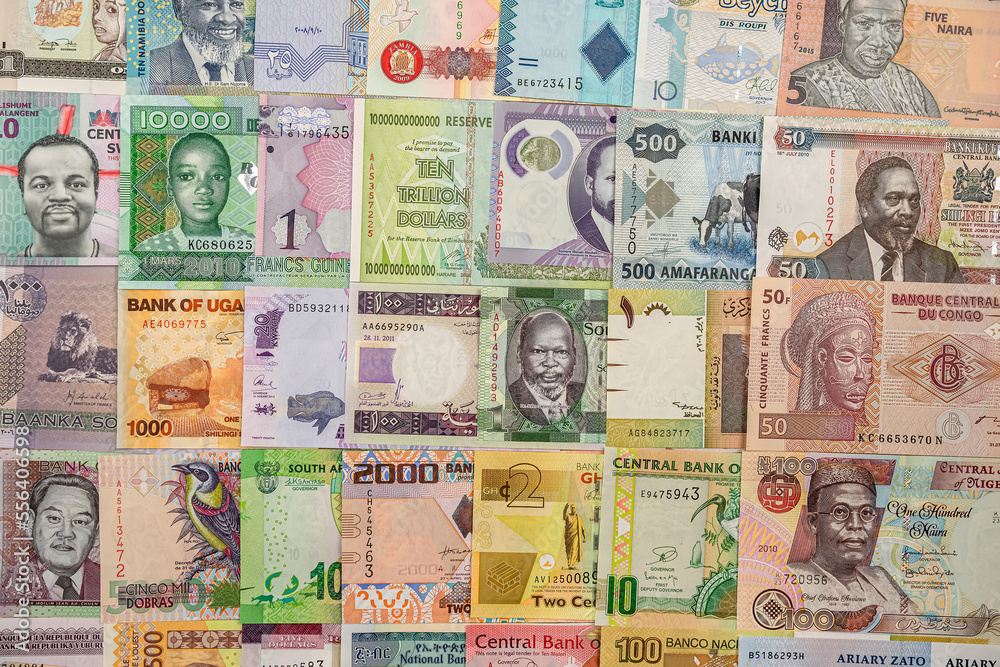 Various African banknotes stacked on top of each other forming a money background.