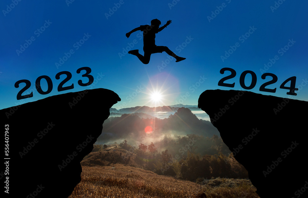 A young man jump between 2023 and 2024 years over the sun and through