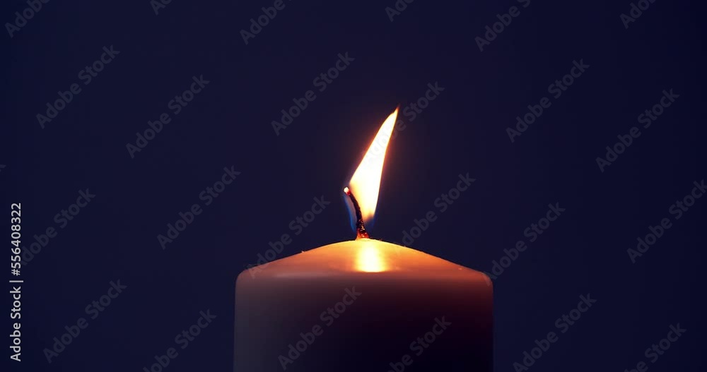 Single big yellow candle flame lights and extinguish, isolated on a black background. Slow motion and close up. Single big yellow candle flame lights and extinguish, isolated on a black background. Slow motion and close up.