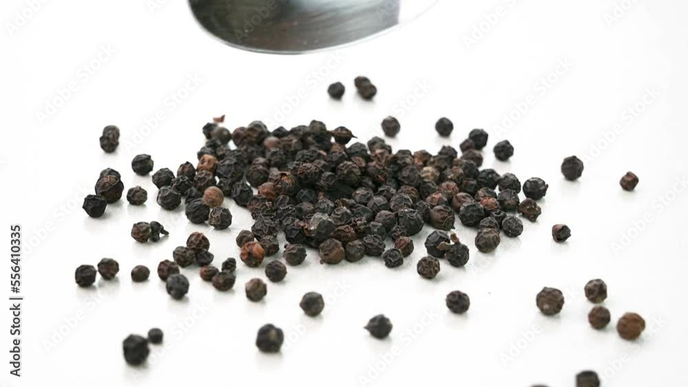 Black peppercorns on a white background Black peppercorns on a white background