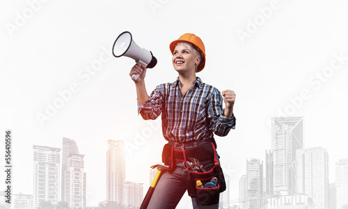 Attractive female construction worker in helmet