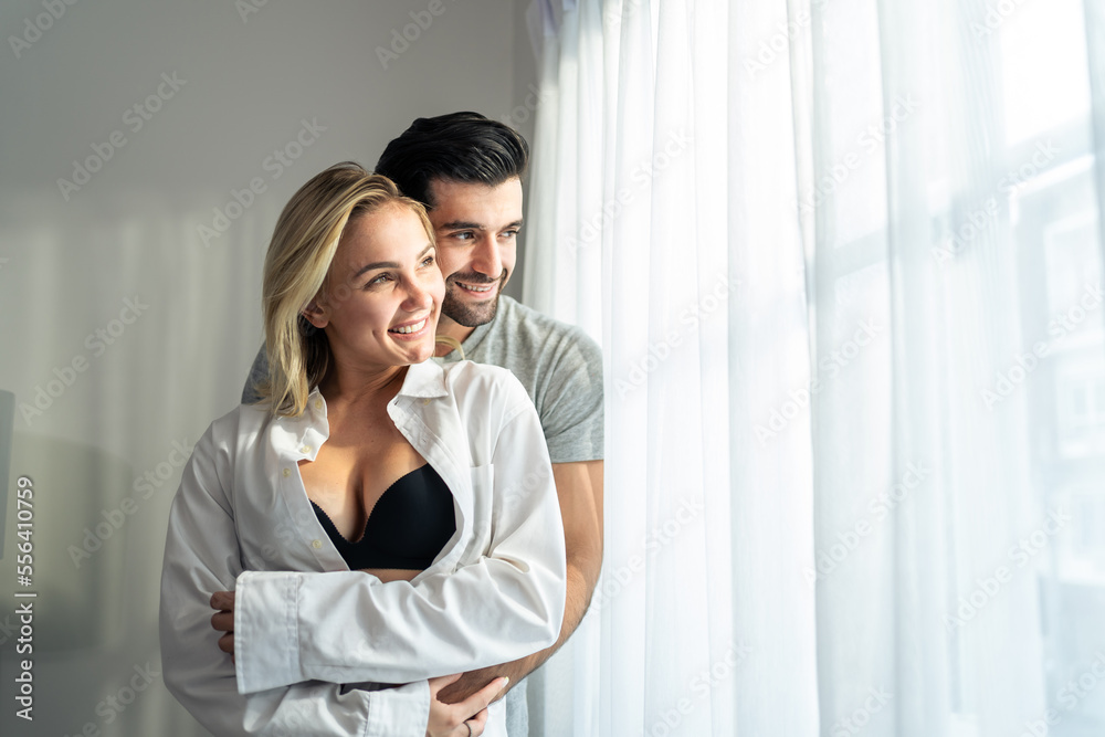 Caucasian young couple spend free leisure time together in living room. Caucasian young couple spend free leisure time together in living room.