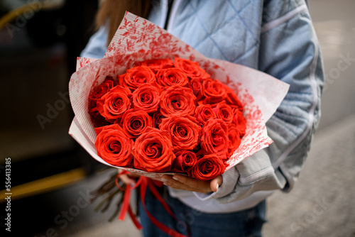 Cuadro en lienzo Selective focus on bright roses buds of flower bouquet in female hands