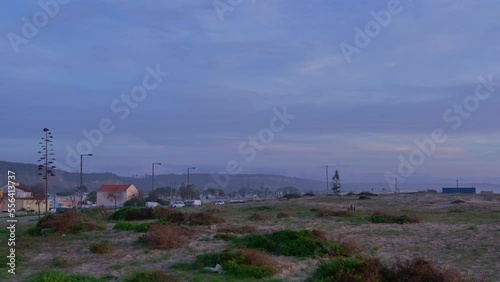 Cars driving around in a suburban area close to the beach photo