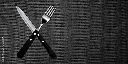 Topview of Set of Fork and Knife on Textured Dark Background photo