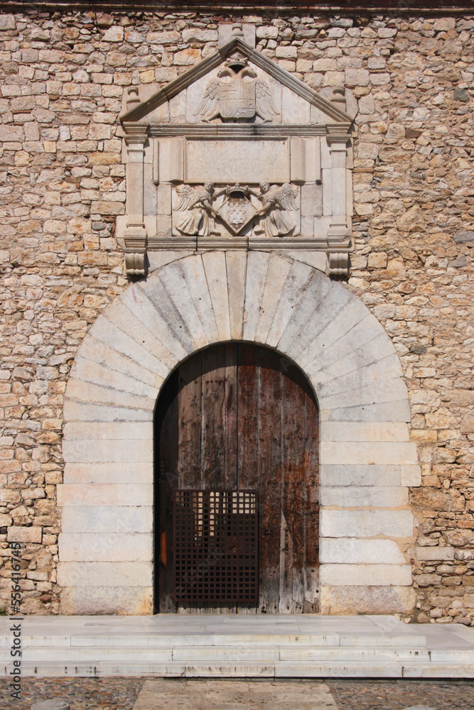Round entrance arch with renaissance pediment at Les Àligues university palace in the old town of Girona, Catalonia region in Spain