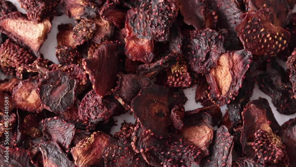 Air-dried strawberries fall on a white surface, slow motion close-up Air-dried strawberries fall on a white surface, slow motion close-up