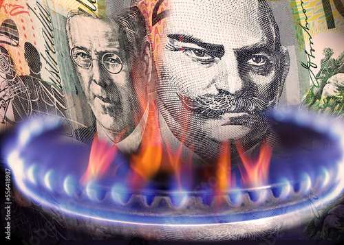 Close up of Australian currency notes on fire, on a gas stove flame. Gas burner. $100 note and $20 note photo