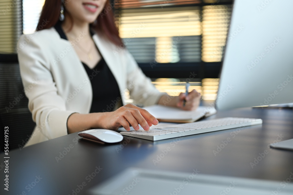 Cropped shot of successful businesswoman working on financial and marketing project at contemporary office Cropped shot of successful businesswoman working on financial and marketing project at contemporary office