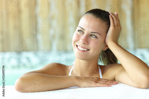 Happy teen in spa looking at side
