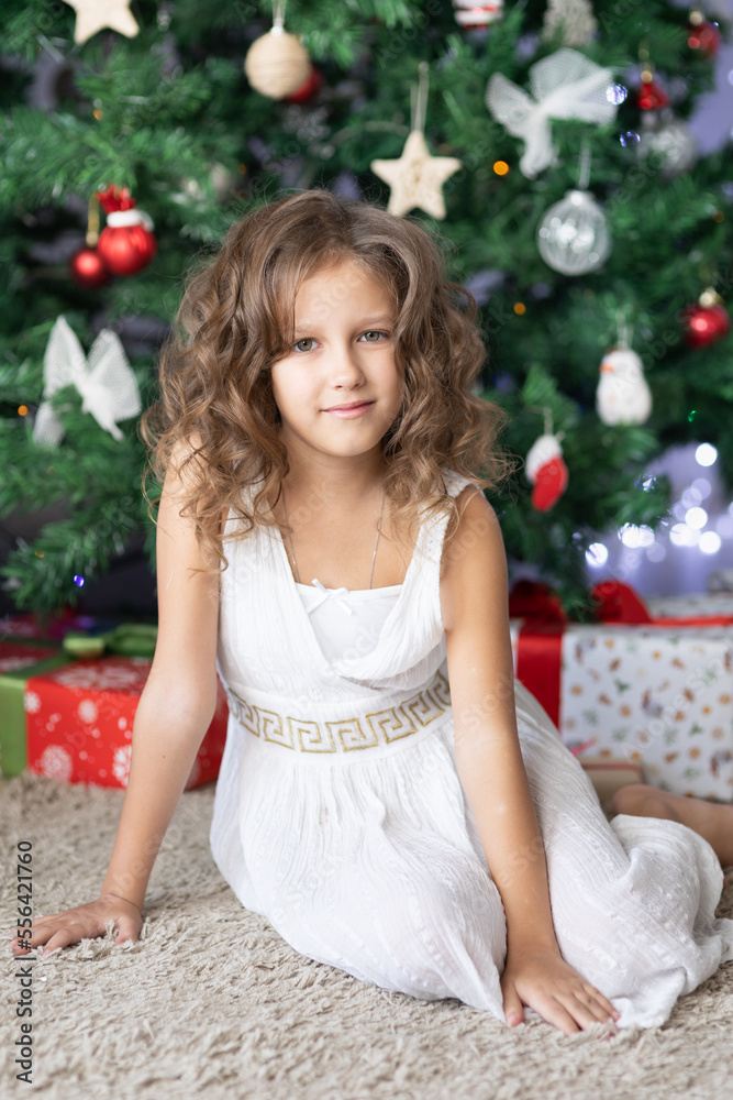 Child girl near christmas tree