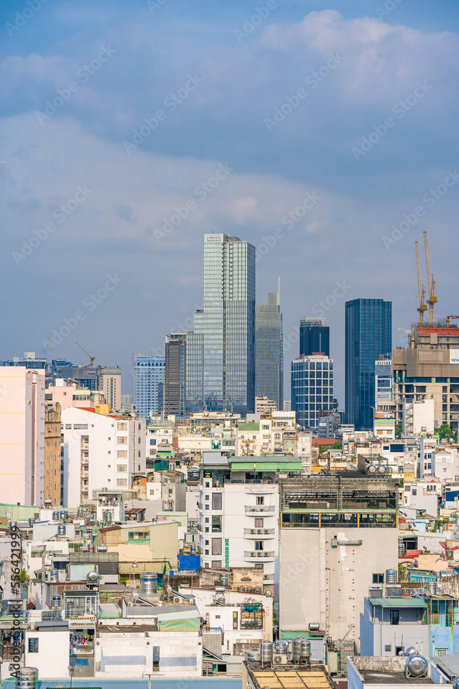 Naklejka premium Ho Chi Minh City, Vietnam - December 20, 2022: Beautiful afternoon in District 1, Ho Chi Minh City, known as Saigon, a developed city of Vietnam with many skyscrapers. View to Bitexco, Landmark 81.
