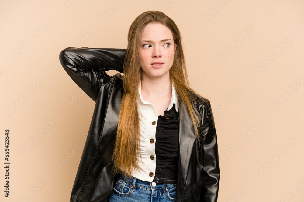 Young redhead woman cut out isolated touching back of head, thinking and making a choice. Young redhead woman cut out isolated touching back of head, thinking and making a choice.
