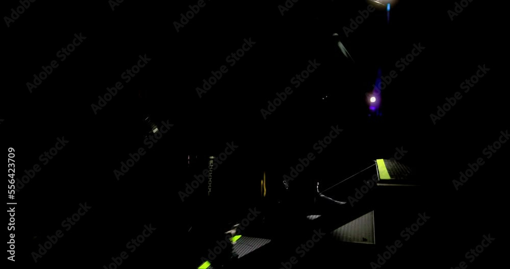 Dramatic, diverse group ascending staircase in Arena venue with dark lighting and spotlight. Dramatic, diverse group ascending staircase in Arena venue with dark lighting and spotlight.