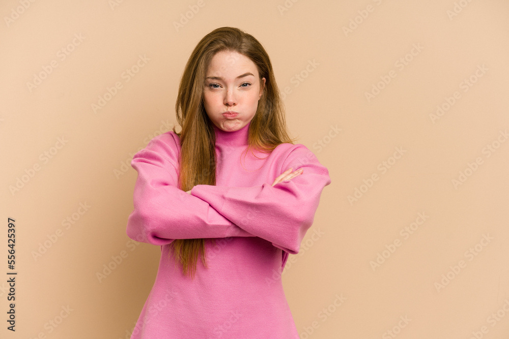 Young redhead woman cut out isolated blows cheeks, has tired expression. Facial expression concept. Young redhead woman cut out isolated blows cheeks, has tired expression. Facial expression concept.