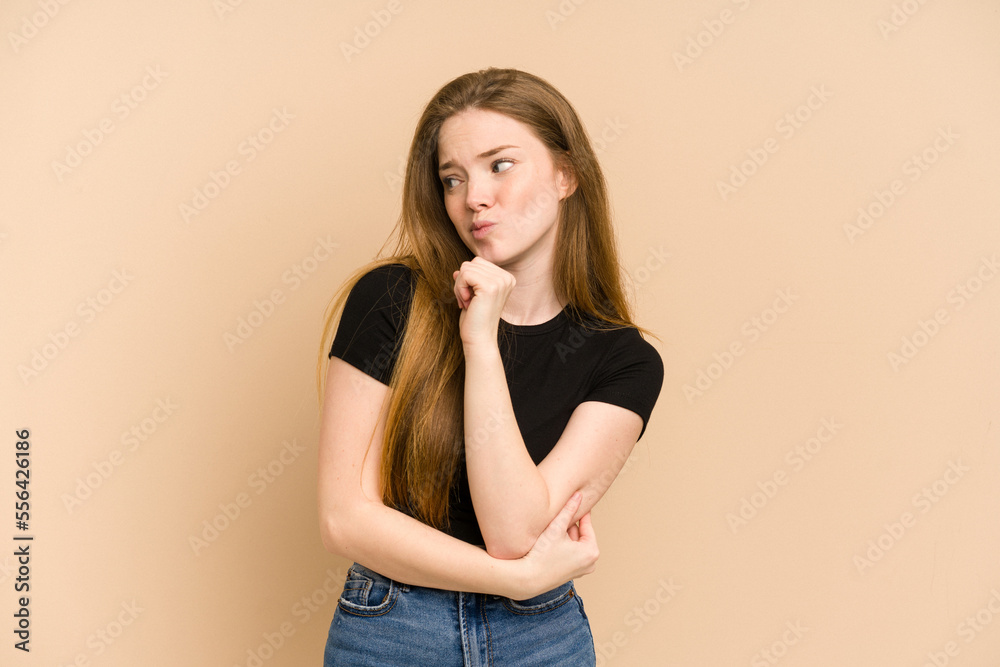 Young redhead woman cut out isolated confused, feels doubtful and unsure. Young redhead woman cut out isolated confused, feels doubtful and unsure.