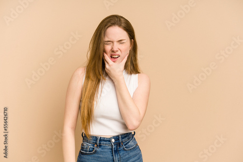 Young redhead woman cut out isolated having a strong teeth pain, molar ache.