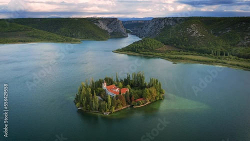 Visovac, Croatia - 4K Flying over the amazing Visovac Christian monastery in Krka National Park on a bright autumn morning with warm lights at sunrise and turquoise blue water