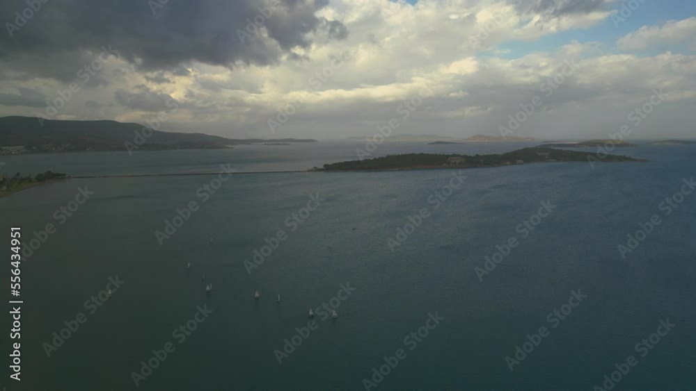 Training sailing yachts class optimist float on the sea.Yachting and sailing training. Summer sport. Aerial view top side of the blue sea and small training sailing yachts with athletes in the regatta