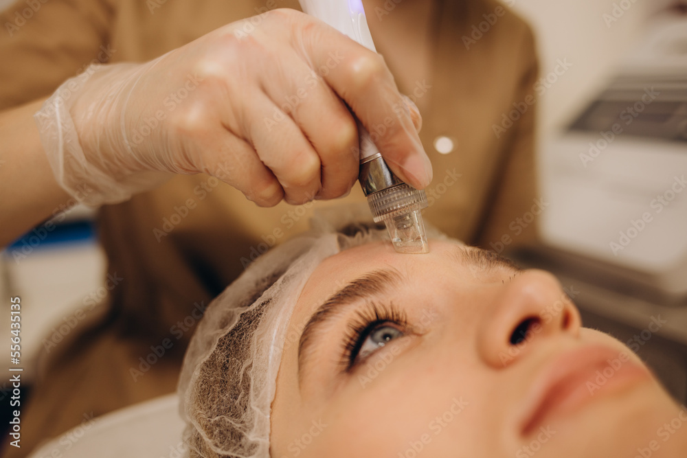 Woman undergoing procedure of vacuum hydro peeling in beauty salon Woman undergoing procedure of vacuum hydro peeling in beauty salon