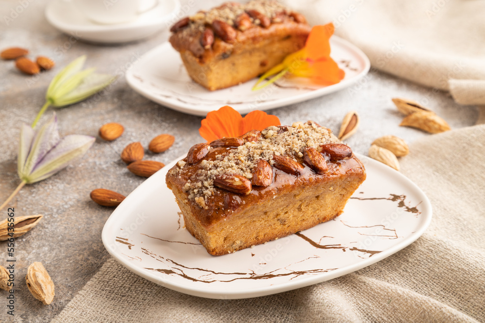 Caramel and almond cake on brown concrete, side view Caramel and almond cake on brown concrete, side view