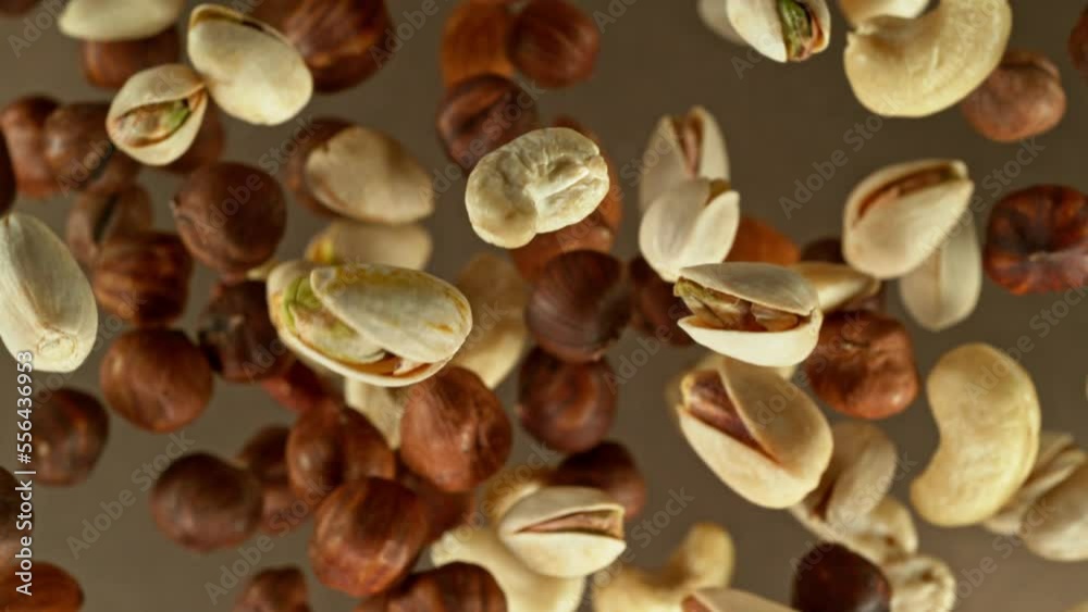 Super slow motion of rotating mix nuts up to the air. Filmed on high speed cinema camera, 1000fps, placed on high speed cine bot. Speed ramp effect. Super slow motion of rotating mix nuts up to the air. Filmed on high speed cinema camera, 1000fps, placed on high speed cine bot. Speed ramp effect.