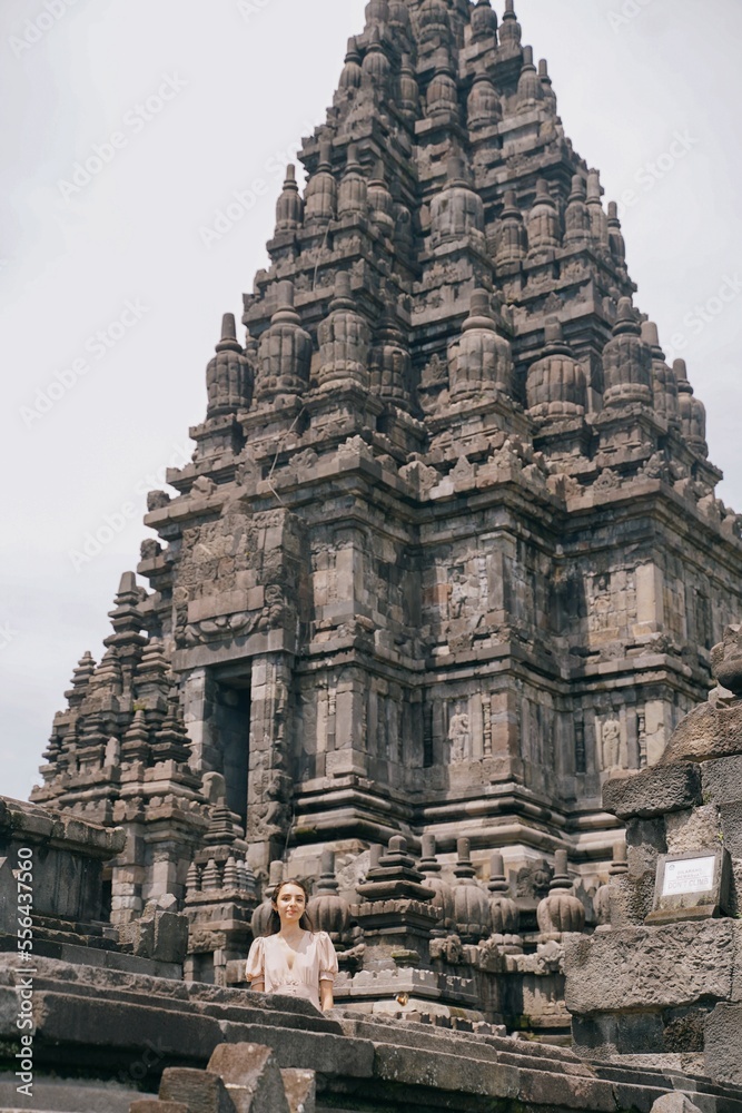 tourist model posing at prambanan temple, yogyakarta indonesia.