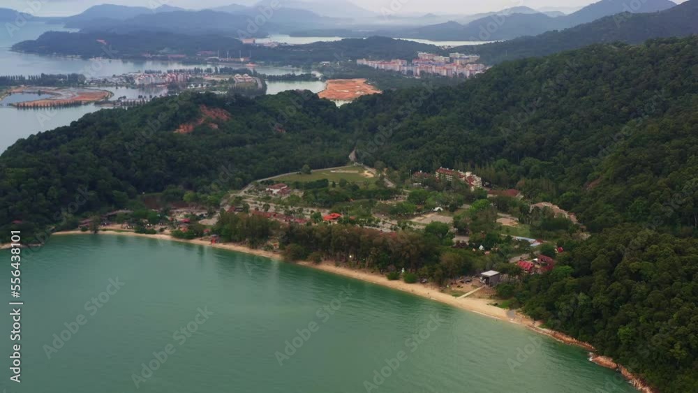 Aerial view drone flyover towards popular tourist spot Teluk Batik beach with marina island and damar laut in the background, straits of malacca, Lumut, Perak, Malaysia, Southeast Asia.