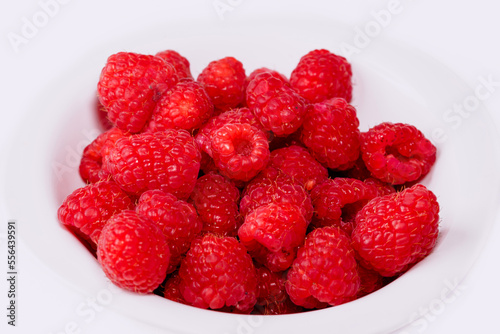 Close up of red raspberries on white background