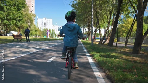 Boy riding on bicycle in the forest. Riding on a hills. 4k video footage UHD 3840x2160 photo