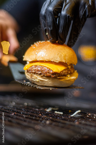 Burger with melted cheese, made on the grill

