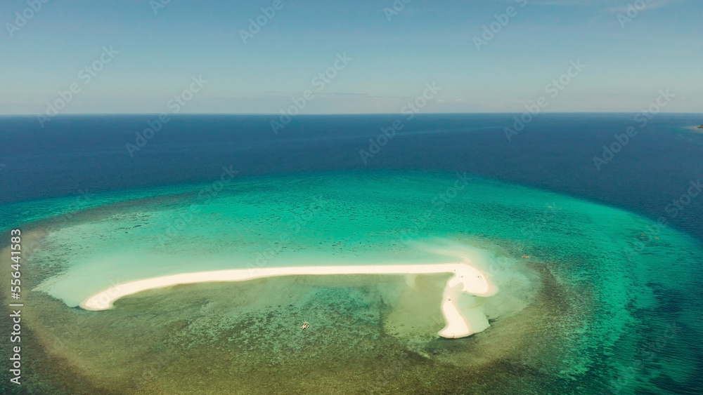 Beautiful beach on tropical island surrounded by coral reef, sandy bar with tourists, top view. Sandbar Atoll. Summer and travel vacation concept, Camiguin, Philippines.