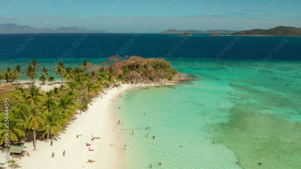 aerial seascape tourists enjoy the tropical beach. tropical island with sand beach, palm trees. Malcapuya, Philippines, Palawan. Tropical landscape with blue lagoon, coral reef aerial seascape tourists enjoy the tropical beach. tropical island with sand beach, palm trees. Malcapuya, Philippines, Palawan. Tropical landscape with blue lagoon, coral reef